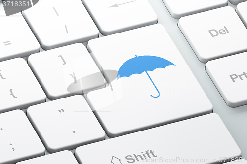 Image of Protection concept: Umbrella on computer keyboard background