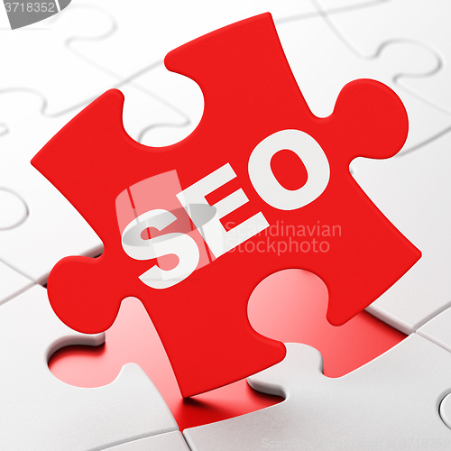 Image of Web development concept: SEO on puzzle background