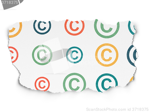 Image of Law concept: Copyright icons on Torn Paper background