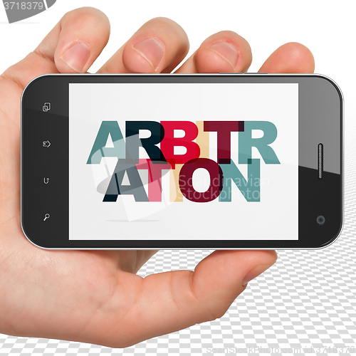 Image of Law concept: Hand Holding Smartphone with Arbitration on  displa