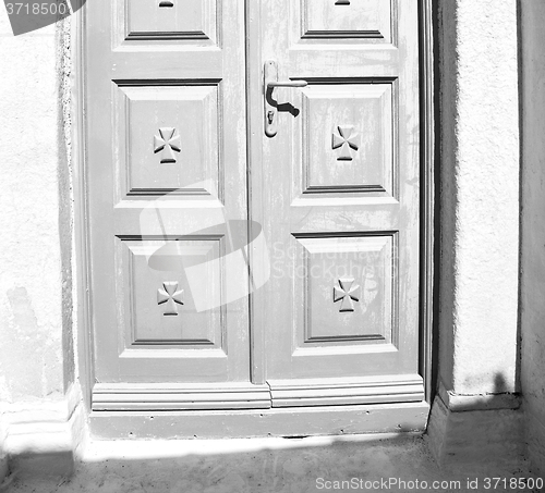 Image of white  red brown  door in antique village santorini greece europ