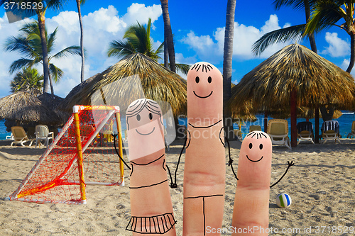 Image of Happy family on the beach. Beachfront football