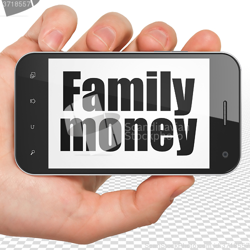 Image of Currency concept: Hand Holding Smartphone with Family Money on display