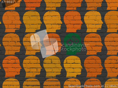 Image of Finance concept: head with gears icon on wall background