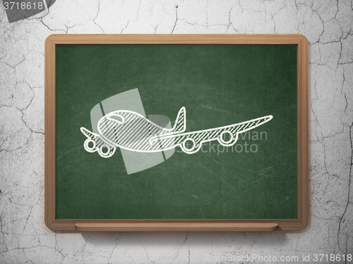 Image of Vacation concept: Airplane on chalkboard background