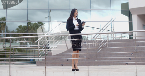 Image of Young businesswoman holding a tablet-pc