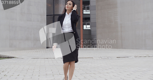 Image of Young businesswoman walking towards the camera