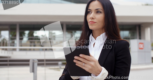 Image of Young contemplative businesswoman