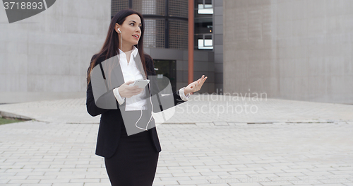 Image of Young businesswoman talking on her mobile