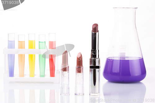 Image of chemical test tubes and lipstick. harmful cosmetics.