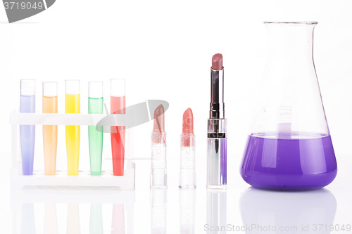 Image of chemical test tubes and lipstick. harmful cosmetics.