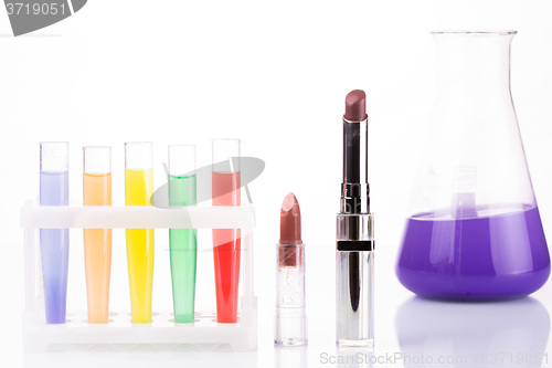 Image of chemical test tubes and lipstick. harmful cosmetics.