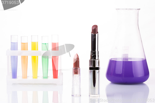 Image of chemical test tubes and lipstick. harmful cosmetics.