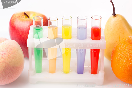 Image of Fruit close chemical test tubes. Genetic Engineering. pesticides in foods