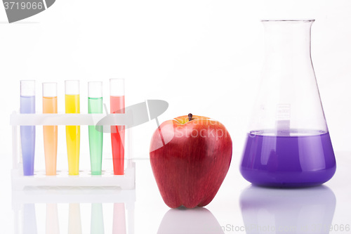 Image of Fruit close chemical test tubes. Genetic Engineering. pesticides in foods