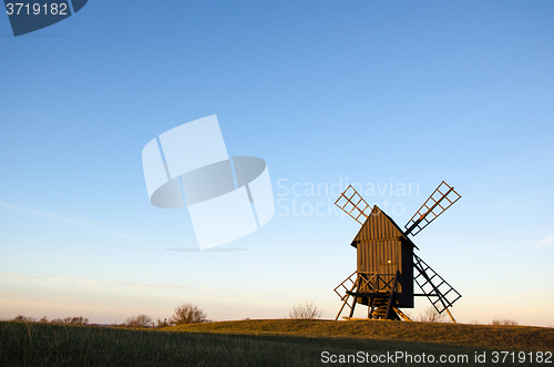 Image of Old wooden windmill in sunlight