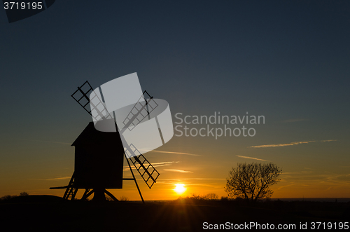 Image of Sunset with silhouette of an old windmill