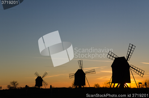 Image of Traditional windmills in a row by sunset