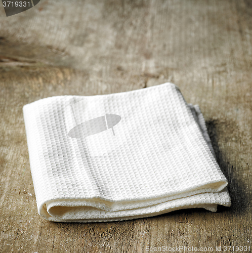 Image of White towel on wooden table