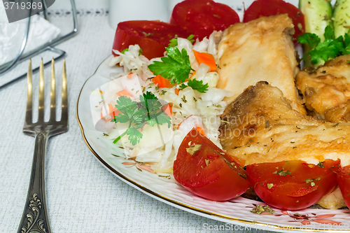 Image of Baked fish and vegetables on the plate.