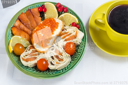 Image of Snacks with fish and black coffee.