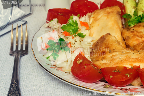 Image of Baked fish and vegetables on the plate.