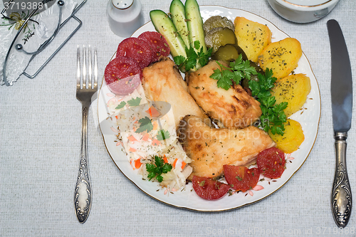 Image of Baked fish and vegetables . The view from the top.