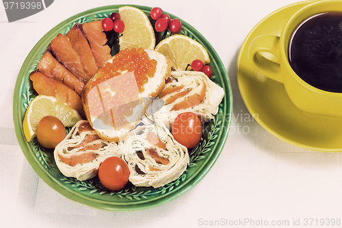 Image of Snacks with fish and black coffee.