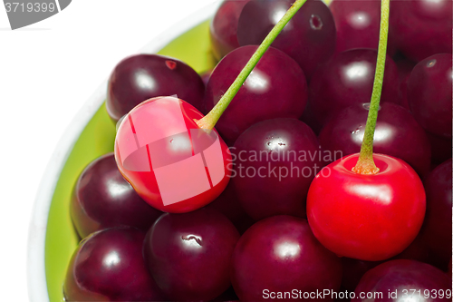 Image of Delicious ripe cherries in a ceramic vase