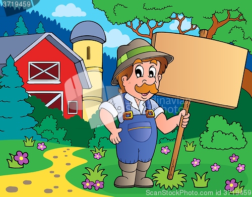 Image of Farmer with sign near farm