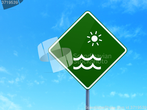 Image of Travel concept: Beach on road sign background