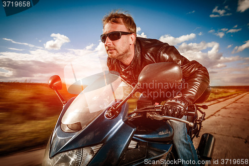 Image of Biker racing on the road