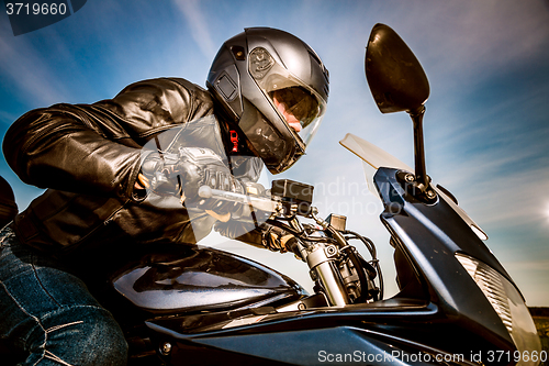 Image of Biker racing on the road