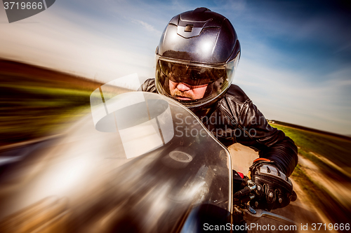 Image of Biker racing on the road