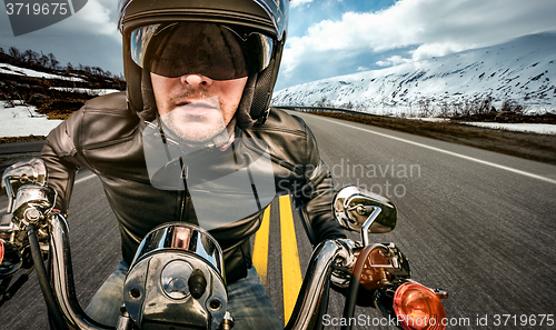 Image of Biker racing on the road