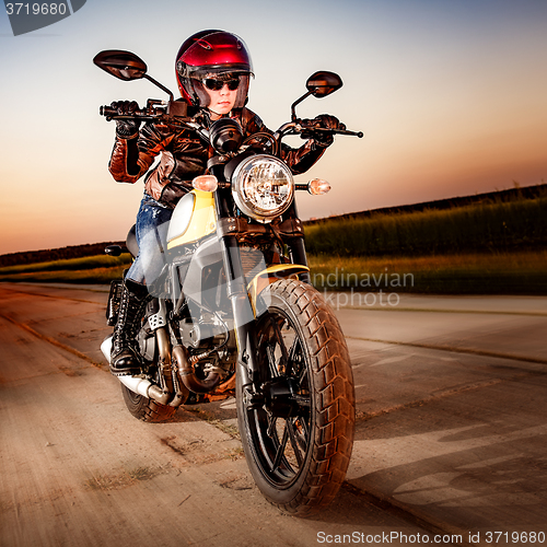 Image of Biker girl on a motorcycle