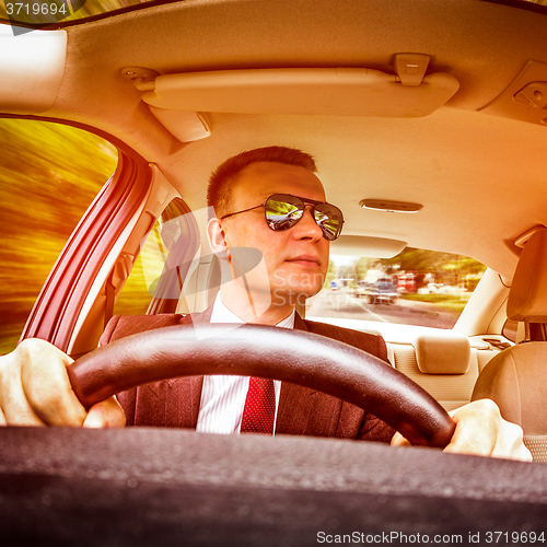 Image of Man driving a car.