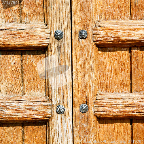 Image of door in italy old ancian wood and trasditional  texture nail