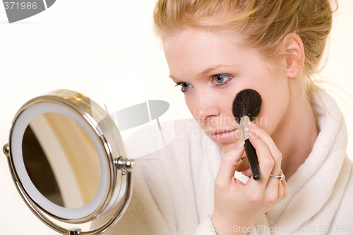 Image of Woman looking in mirror