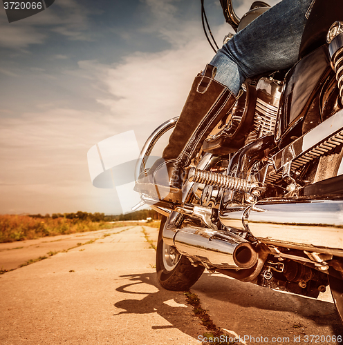 Image of Biker girl riding on a motorcycle