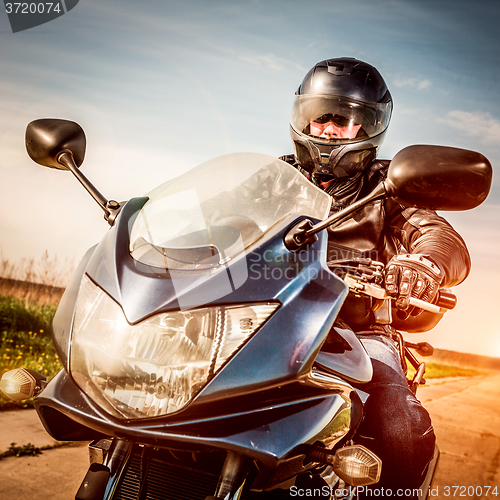 Image of Biker racing on the road