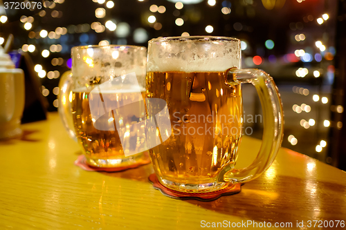 Image of Two cups of beer in a pub