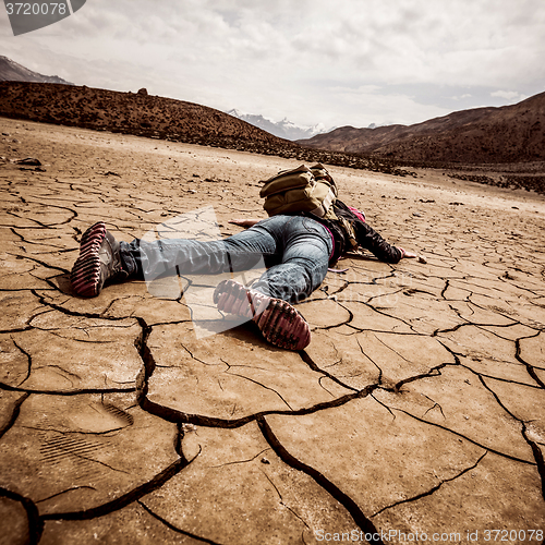 Image of person lays on the dried ground