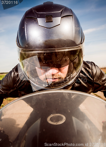 Image of Biker racing on the road