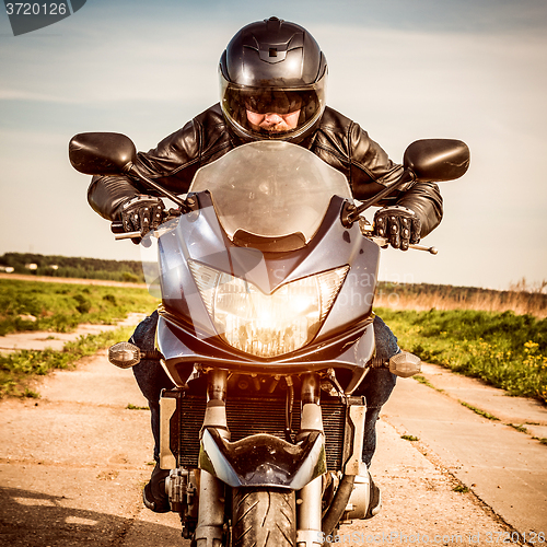 Image of Biker racing on the road