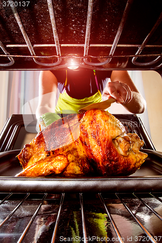 Image of Cooking chicken in the oven at home.