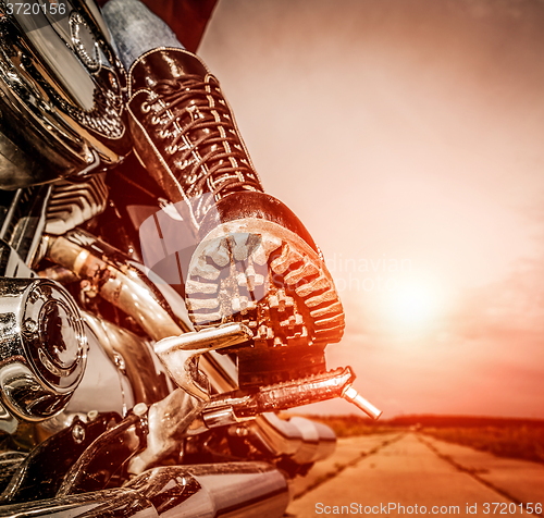 Image of Biker girl riding on a motorcycle