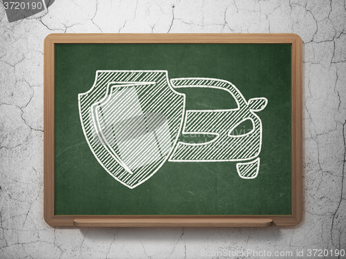 Image of Insurance concept: Car And Shield on chalkboard background