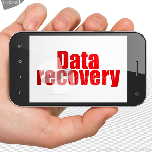 Image of Information concept: Hand Holding Smartphone with Data Recovery on display