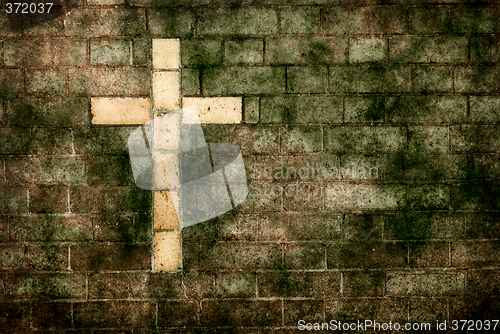 Image of cross of christ built into a brick wall